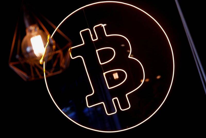 A neon logo of cryptocurrency Bitcoin is seen at the Crypstation cafe, in downtown Buenos Aires