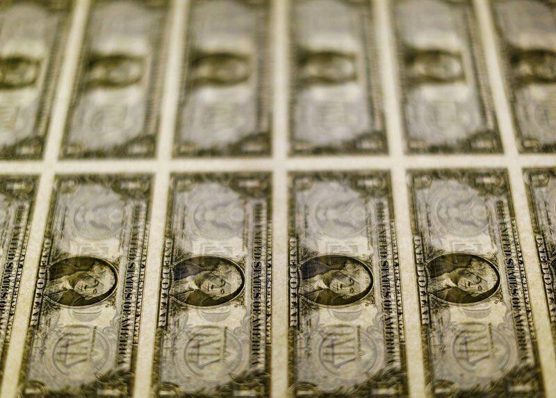 File photo of United States one dollar bills seen on a light table at the Bureau of Engraving and Printing in Washington